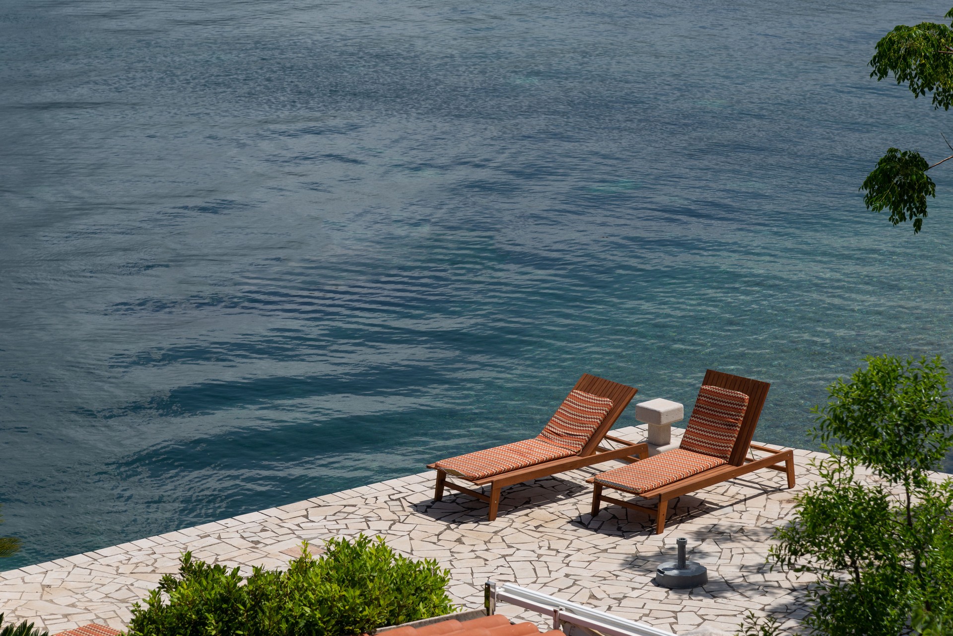 Private beach villa, blue sea and beach chairs, stock photo